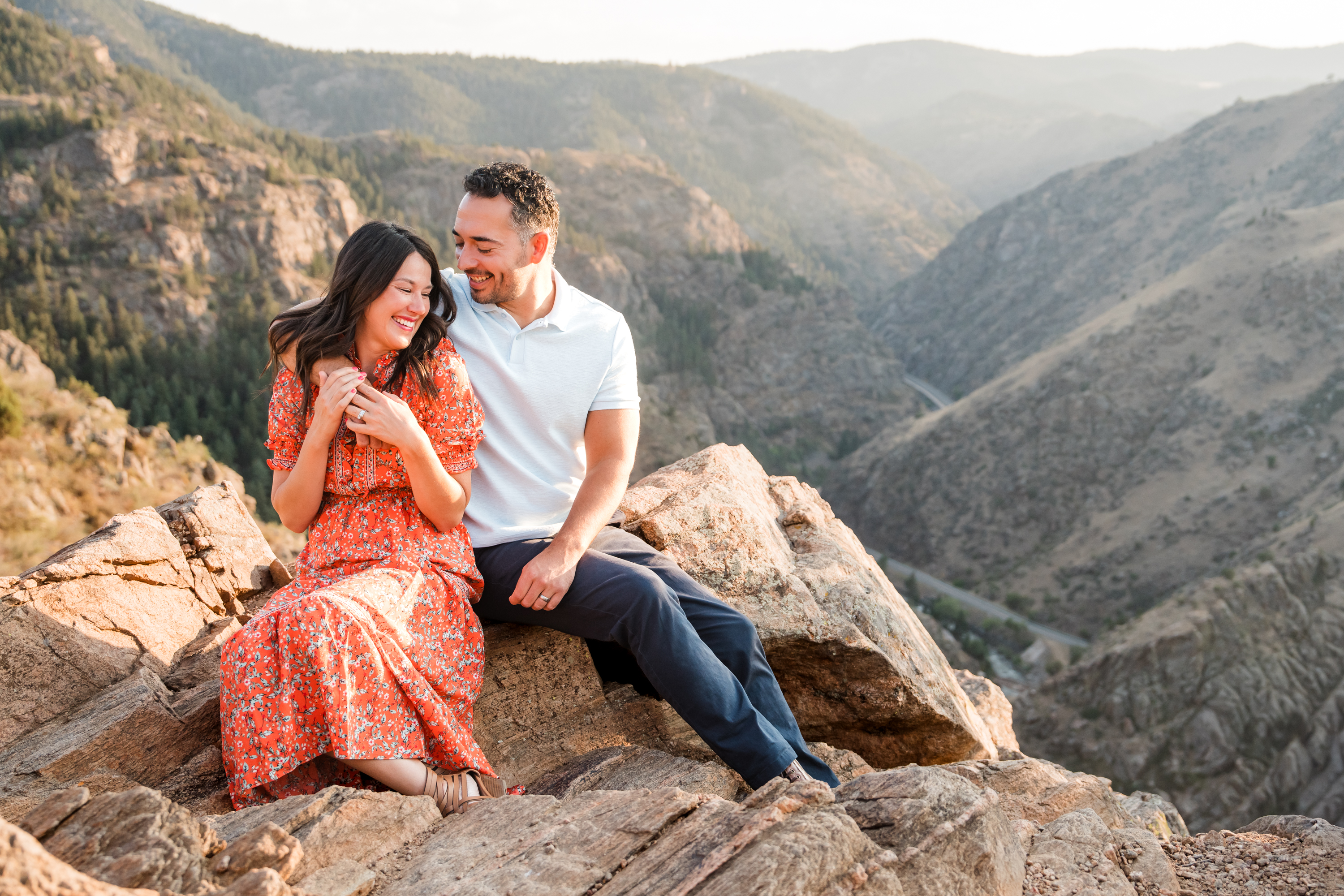 Caleb and Sara sitting together in the Colorado mountains
