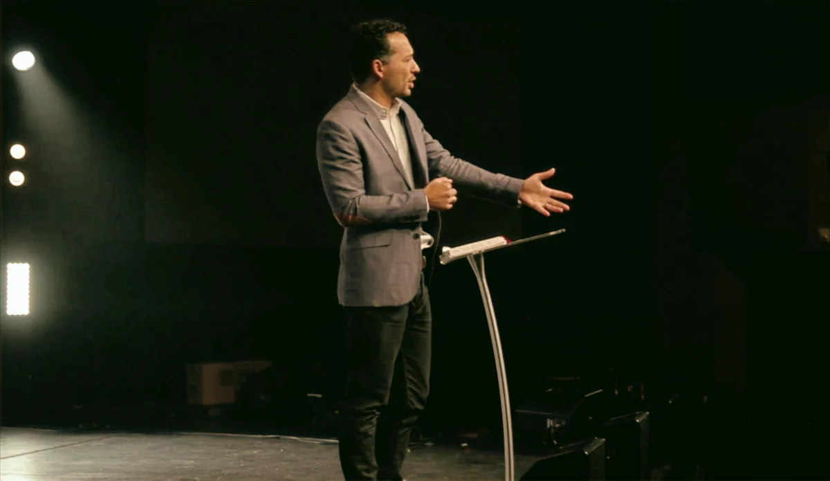 Caleb preaching from an open Bible